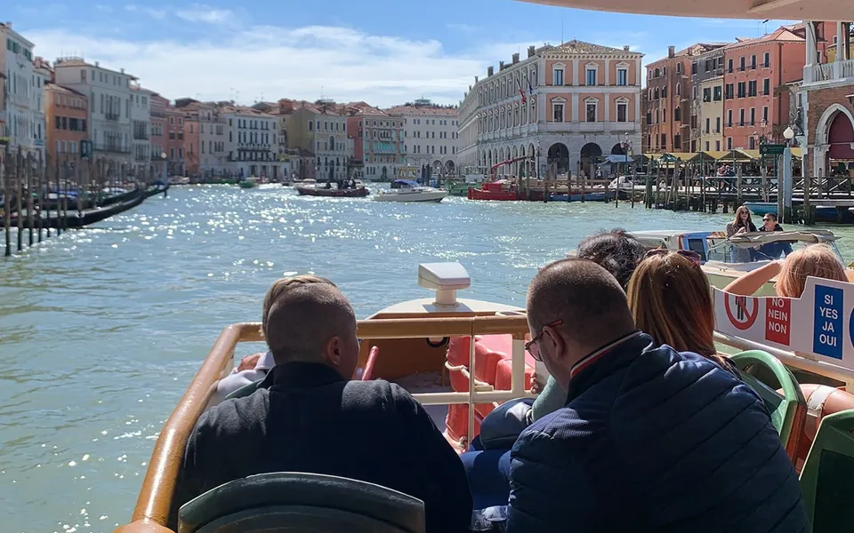 Passengers travelling along the Grand Canal on a public water bus