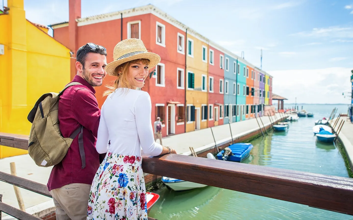 Visitors by a canal and colourful houses on Burano