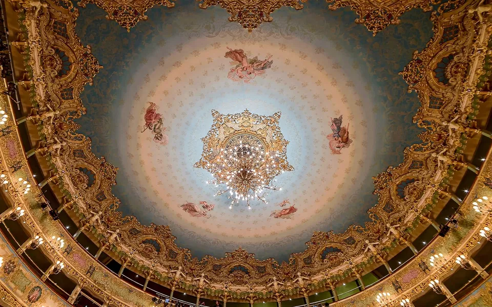 Decorated ceiling and chandelier inside La Fenice